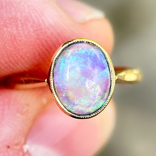 3 - An Opal Ring in 9k yellow gold, set with a cabochon opal. Stamped 9ct.

Size: I1/2
Weight: 1.8g