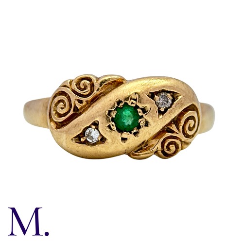 6 - An Emerald And Diamond Ring in 9k yellow gold, set with a round cut emerald flanked either side with... 