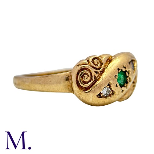 6 - An Emerald And Diamond Ring in 9k yellow gold, set with a round cut emerald flanked either side with... 