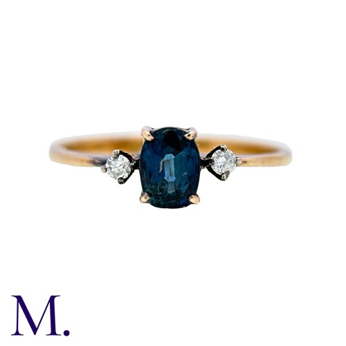 17 - A Sapphire And Diamond Ring in 14k yellow gold, set with an oval cut sapphire between two round cut ... 