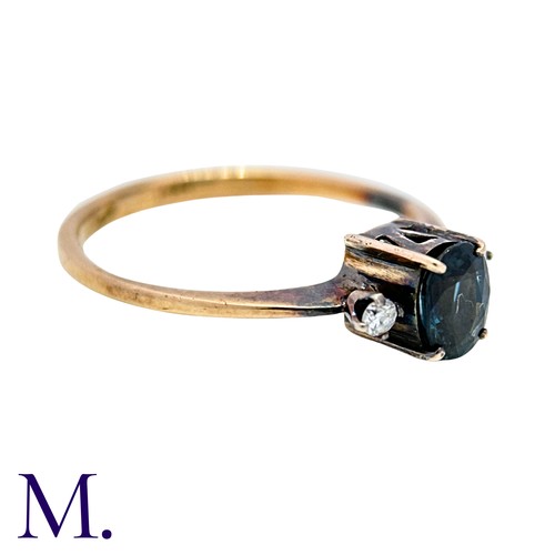 17 - A Sapphire And Diamond Ring in 14k yellow gold, set with an oval cut sapphire between two round cut ... 