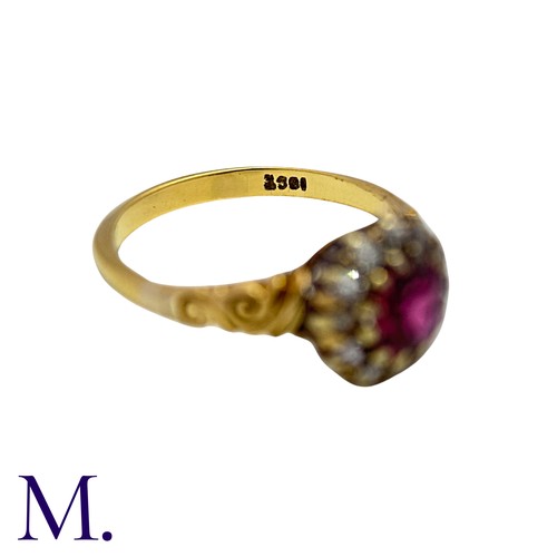 5 - A Ruby And Diamond Cluster Ring in 18k yellow gold, set with a round cut ruby within an old cut diam... 