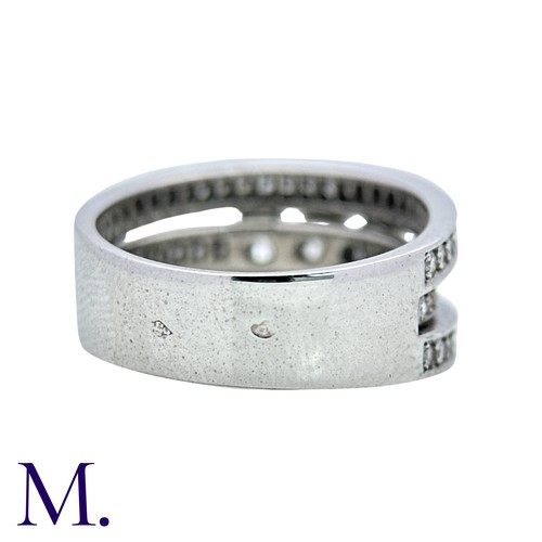 52 - A Diamond Ring in 18k white gold, set with three principal round cut diamonds, set to three pavé set... 