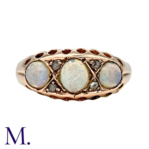 425 - An Opal And Diamond Ring in 9k yellow gold, set with three cabochon opals punctuated by pairs of ros... 