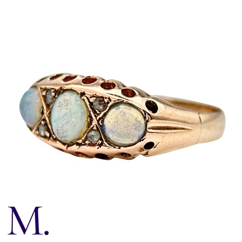 425 - An Opal And Diamond Ring in 9k yellow gold, set with three cabochon opals punctuated by pairs of ros... 