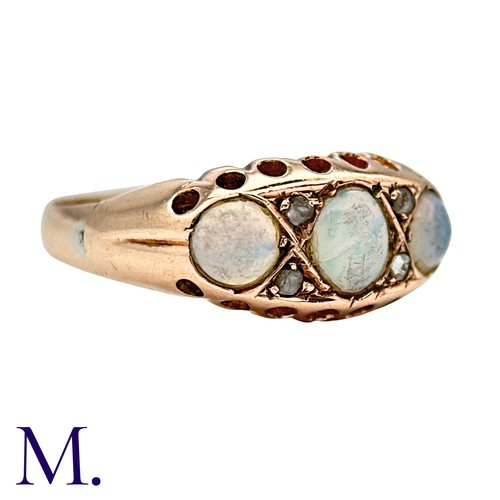 425 - An Opal And Diamond Ring in 9k yellow gold, set with three cabochon opals punctuated by pairs of ros... 