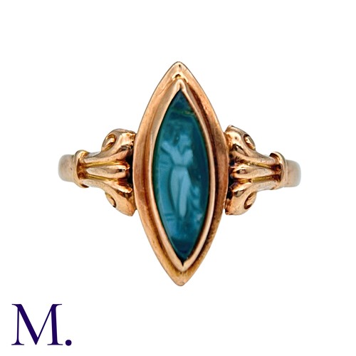 210 - A Cameo Ring in 9k yellow gold, the navette shaped face set with a carved green cameo, to scrolling ... 