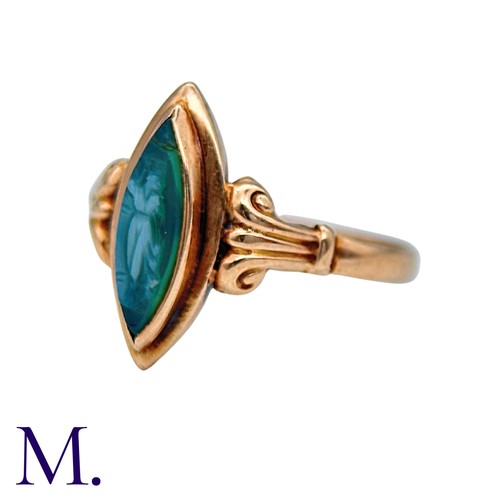 210 - A Cameo Ring in 9k yellow gold, the navette shaped face set with a carved green cameo, to scrolling ... 