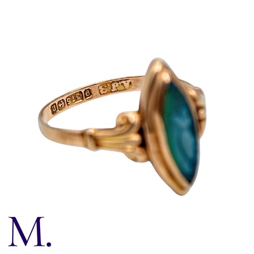 210 - A Cameo Ring in 9k yellow gold, the navette shaped face set with a carved green cameo, to scrolling ... 