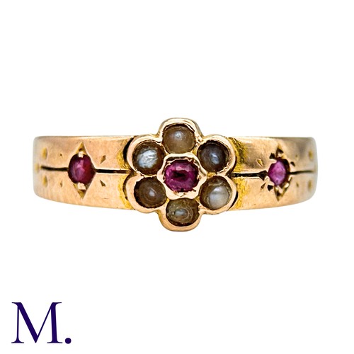 25 - A Ruby And Pearl Gypsy Ring in 15k yellow gold, set with a round cut ruby within a pearl border, fla... 