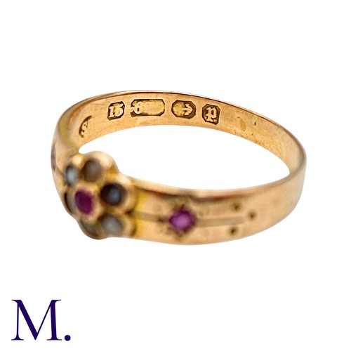25 - A Ruby And Pearl Gypsy Ring in 15k yellow gold, set with a round cut ruby within a pearl border, fla... 