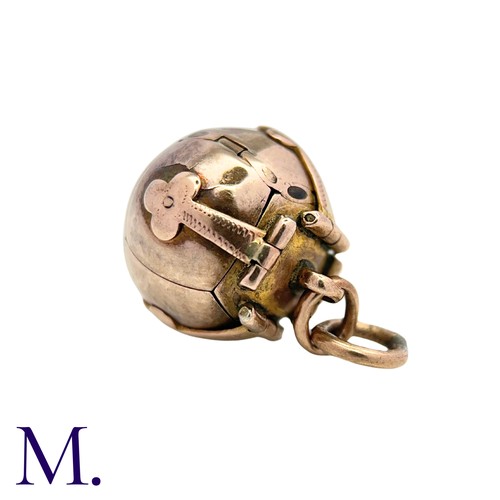 24 - A Masonic Orb Pendant in 9k yellow gold and silver, the hinged spherical body opens to display a cro... 