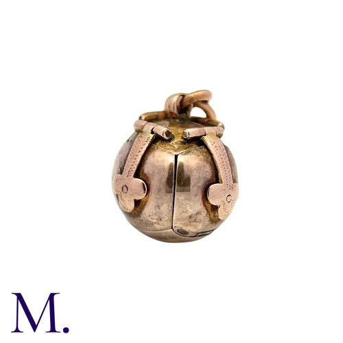 24 - A Masonic Orb Pendant in 9k yellow gold and silver, the hinged spherical body opens to display a cro... 