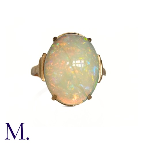 11 - An Opal Ring in 9k yellow gold, set with a cabochon opal to stepped shoulders. Stamped 9ct.

Size: J... 