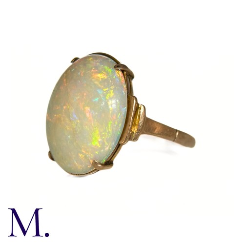 11 - An Opal Ring in 9k yellow gold, set with a cabochon opal to stepped shoulders. Stamped 9ct.

Size: J... 