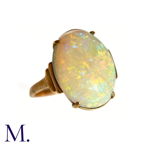 11 - An Opal Ring in 9k yellow gold, set with a cabochon opal to stepped shoulders. Stamped 9ct.

Size: J... 
