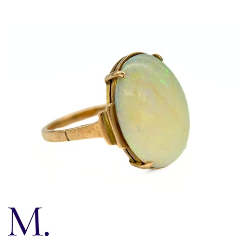 11 - An Opal Ring in 9k yellow gold, set with a cabochon opal to stepped shoulders. Stamped 9ct.

Size: J... 