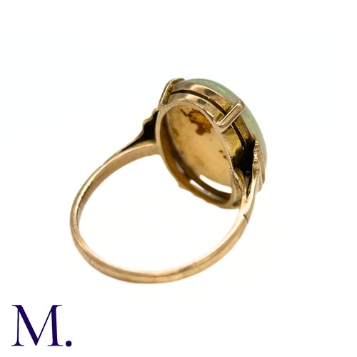 11 - An Opal Ring in 9k yellow gold, set with a cabochon opal to stepped shoulders. Stamped 9ct.

Size: J... 