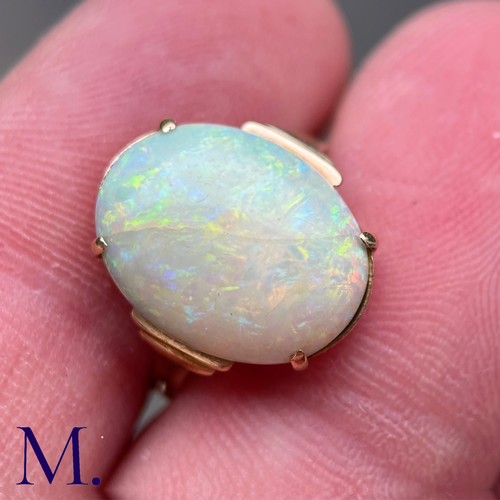 11 - An Opal Ring in 9k yellow gold, set with a cabochon opal to stepped shoulders. Stamped 9ct.

Size: J... 