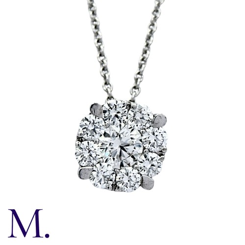 214 - A Diamond Pendant and Chain in 18K white gold.  Pendant set with a round brilliant diamond weighing ... 