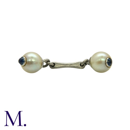 219 - A Pair of Pearl and Sapphire Cufflinks in white gold set with pearls of approximately 7.5mm diameter... 