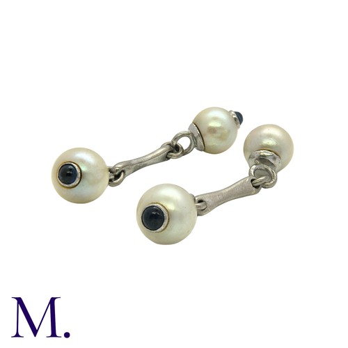 219 - A Pair of Pearl and Sapphire Cufflinks in white gold set with pearls of approximately 7.5mm diameter... 