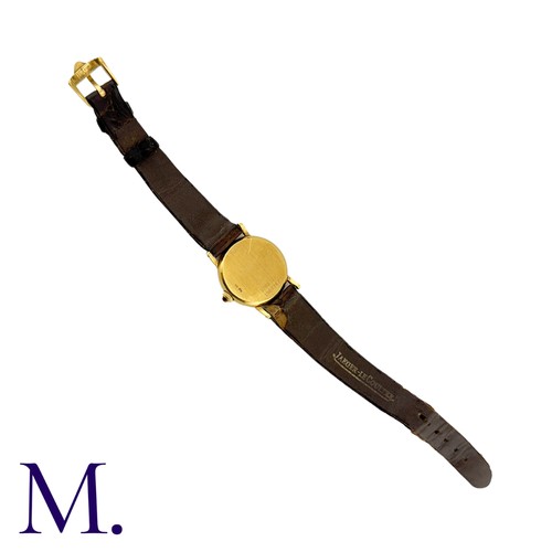 227 - JAEGER-LECOULTRE. A Gold Wristwatch, with brushed Champagne coloured dial and tigers-eye set crown. ... 