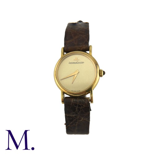 227 - JAEGER-LECOULTRE. A Gold Wristwatch, with brushed Champagne coloured dial and tigers-eye set crown. ... 