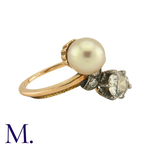 185 - A Diamond And Pearl Toi Et Moi Ring in yellow gold, set with a principal old cut diamond of approxim... 