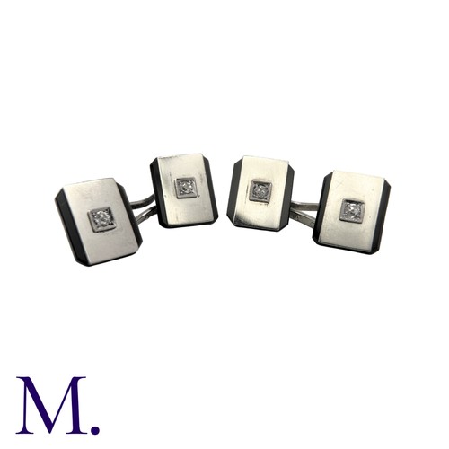 228 - A Pair of Onyx And Diamond Cufflinks in platinum, each set with a diamond weighing approximately 0.1... 