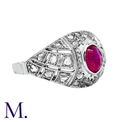205 - An Antique Ruby and Diamond Bombe Ring in platinum, set with a cabochon ruby (accompanied with a gem... 
