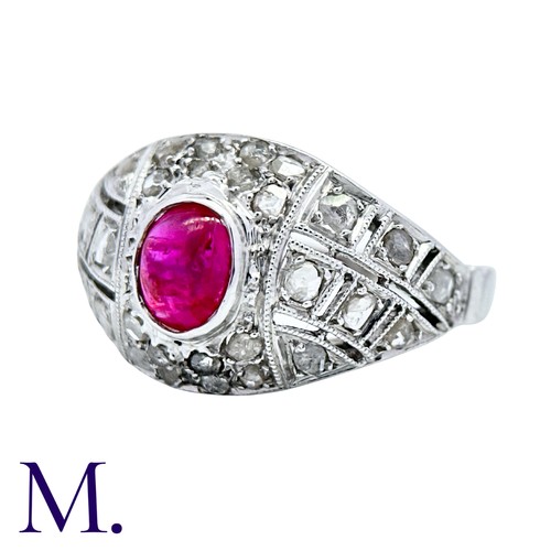 205 - An Antique Ruby and Diamond Bombe Ring in platinum, set with a cabochon ruby (accompanied with a gem... 