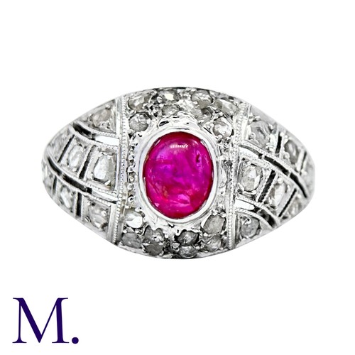 205 - An Antique Ruby and Diamond Bombe Ring in platinum, set with a cabochon ruby (accompanied with a gem... 