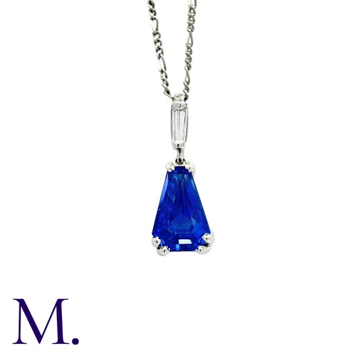 196 - A Sapphire and Diamond Pendant with Chain in 18K white gold, set with a tapered faceted sapphire (ac... 