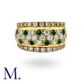 An Emerald And Diamond Ring in 18k yellow gold, set with round cut ...