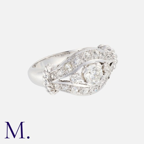 10 - A Diamond Ring in platinum set with three round cut stones to the centre, the largest of which is ap... 