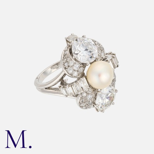 51 - BOUCHERON. A Pearl and Diamond Ring with box.  Set with two round transitional cut diamonds above ei... 