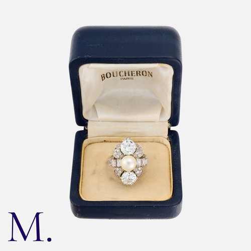 51 - BOUCHERON. A Pearl and Diamond Ring with box.  Set with two round transitional cut diamonds above ei... 