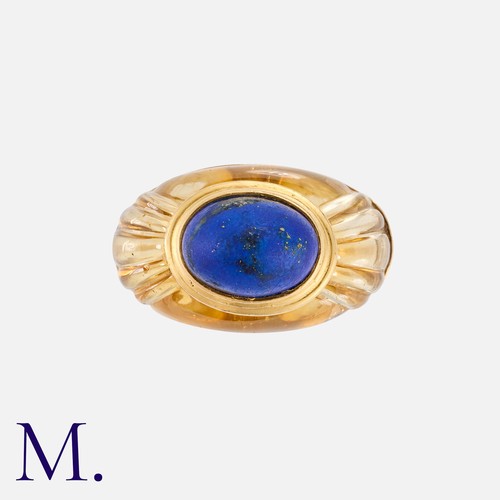 50 - BOUCHERON. A Citrine & Lapis Ring in 18k yellow gold, of bombe form, set with a carved citrine inlai... 