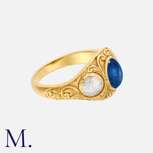 29 - An Antique Sapphire And Diamond Three Stone Ring in yellow gold, set with a principal cabochon sapph... 