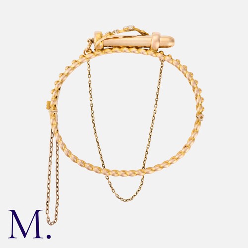 26 - An Antique Pencil Bangle in 9k yellow gold, the hinged, decorative bangle featuring a retractable pe... 