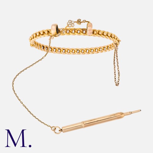 26 - An Antique Pencil Bangle in 9k yellow gold, the hinged, decorative bangle featuring a retractable pe... 