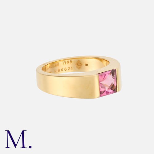 19 - CARTIER. A Pink Tourmaline Tank Ring in 18K yellow gold.  Set with a faceted pink tourmaline cabocho... 