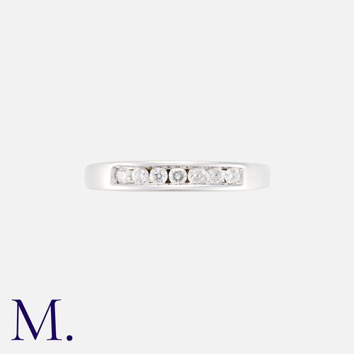 2 - A Diamond Band with 7 channel-set brilliant cut diamonds in 18K white gold.  Hallmarked.

Size: K
We... 