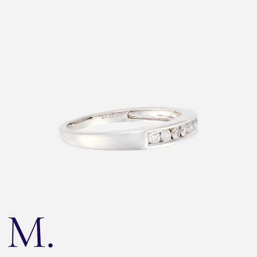 2 - A Diamond Band with 7 channel-set brilliant cut diamonds in 18K white gold.  Hallmarked.

Size: K
We... 