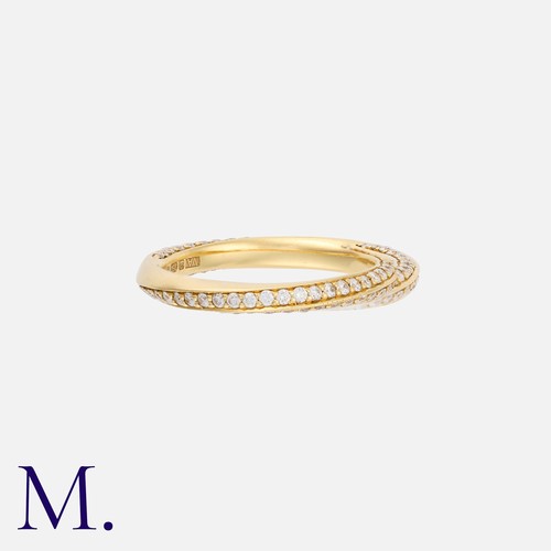 17 - A Diamond Twist Band in 18K yellow gold, set with round brilliant diamonds weighing approximately 0.... 