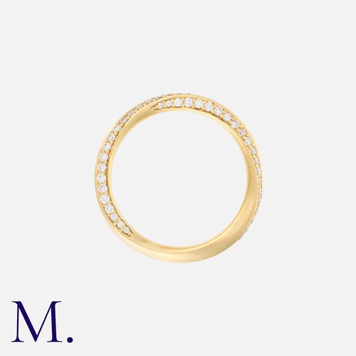 17 - A Diamond Twist Band in 18K yellow gold, set with round brilliant diamonds weighing approximately 0.... 