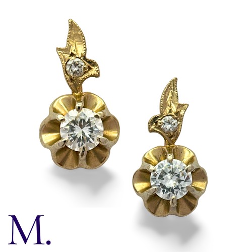 158 - A Pair Of Diamond Drop Earrings in 14k yellow and white gold, each comprising a round cut diamond to... 