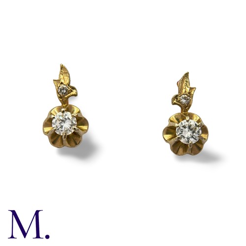 158 - A Pair Of Diamond Drop Earrings in 14k yellow and white gold, each comprising a round cut diamond to... 