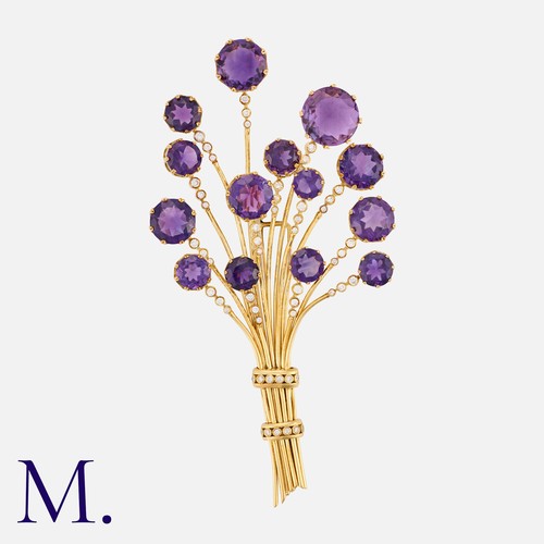 75 - An Amethyst And Diamond Brooch in yellow gold, of floral, spray design set with fifteen round cut am... 